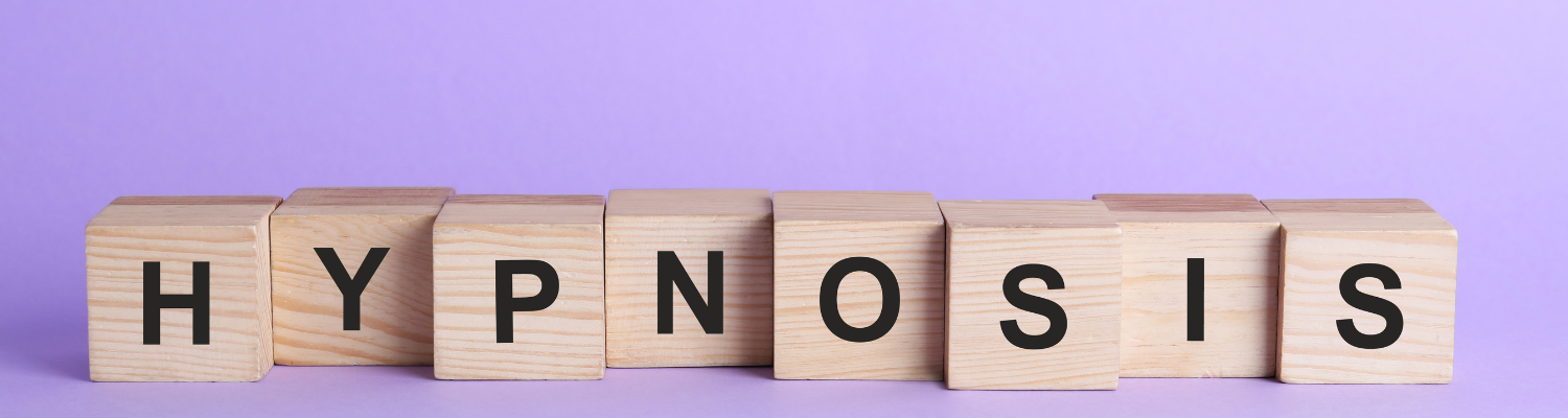 hypnosis written on wooden block in front of a purple background